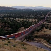 Border barrier of shipping containers snakes across Arizona wilderness