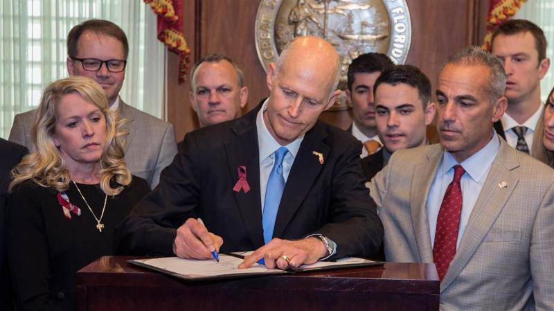NRA sues Florida over gun bill same day Gov. Scott signed it into law