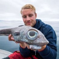 Fisherman gets shock as he reels in 'dinosaur-like' fish with huge eyes