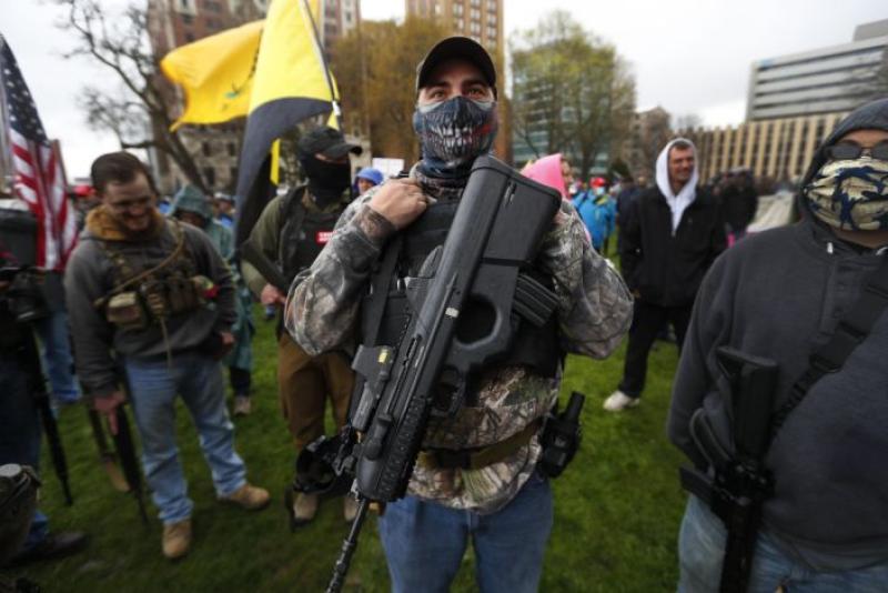 Armed protesters in Michigan foreshadow a tense election season in key swing state