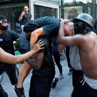 Black Lives Matter protester seen carrying a white man through an angry crowd in London says he wants 'equality for all races and people'