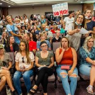 School hearing dismissed after angry parents pack room without masks