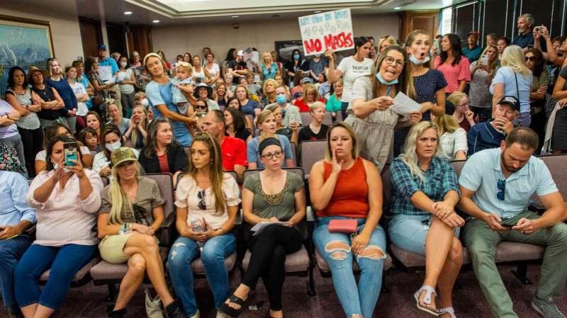 School hearing dismissed after angry parents pack room without masks
