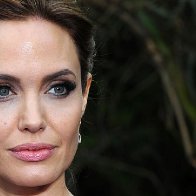 Angelina Jolie stands perfectly still, unshowered, covered in bees for World Bee Day