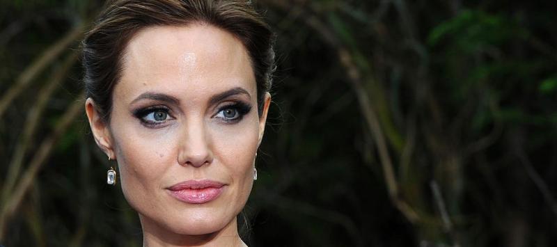 Angelina Jolie stands perfectly still, unshowered, covered in bees for World Bee Day