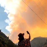 California fire prompts evacuations; Oregon blaze balloons