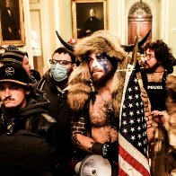 Capitol Rioter Known as QAnon Shaman Pleads Guilty - The New York Times