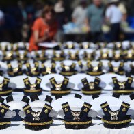 Coast Guard Academy settles suit over cadets-with-kids ban | AP News