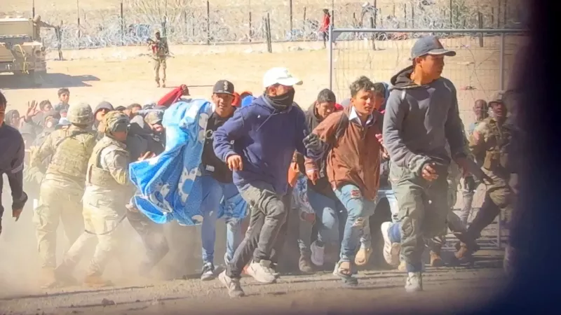 Over 100 migrants break through razor wire, knock down guards as they illegally cross El Paso border in wild scene