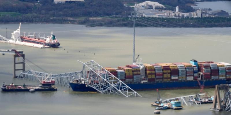 Containers being moved from ship to access fallen Baltimore bridge's roadway