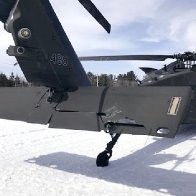 A snowmobiler who crashed into a parked Black Hawk helicopter is awarded $3 million