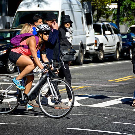 urban-life-new-york-city-female-bicyclist-at-manhattan-intersection-picture-id501478138