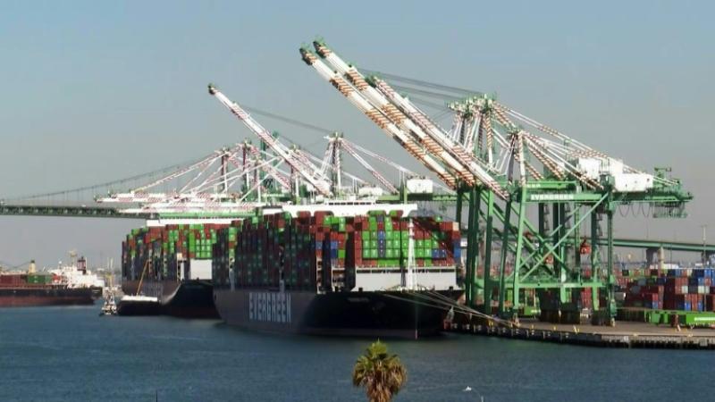 Hundreds of truck drivers wait for dozens of ships to unload their containers in California as the White House announces that it will now work 24 hours a day in an attempt clear the backlog