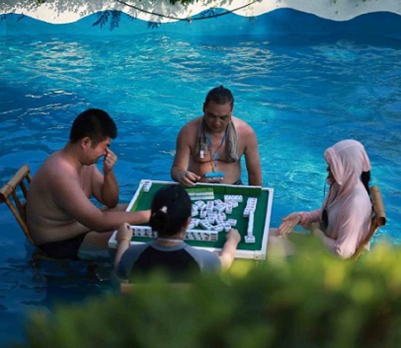 Chongqing residents play mahjong in water to cool off