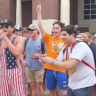 A white Ole Miss frat boy dances like a monkey and makes monkey noises near a Black woman who was protesting for Palestine.