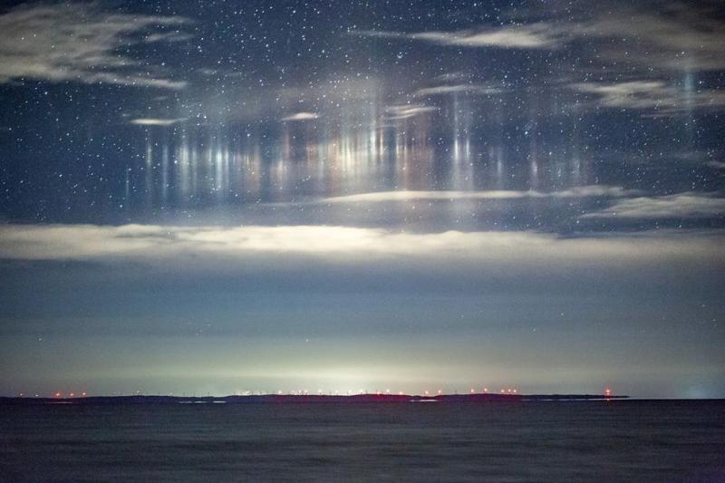 Otherworldly light pillars captured over Whitefish Bay